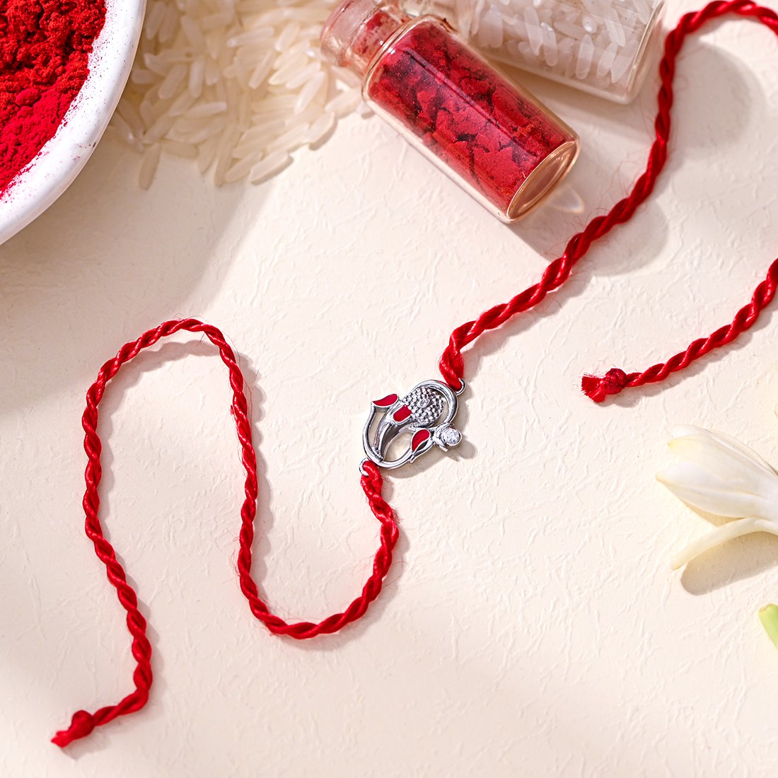 Auspicious Lord Ganesh Ji CZ Gold Plated Silver Thread Rakhi